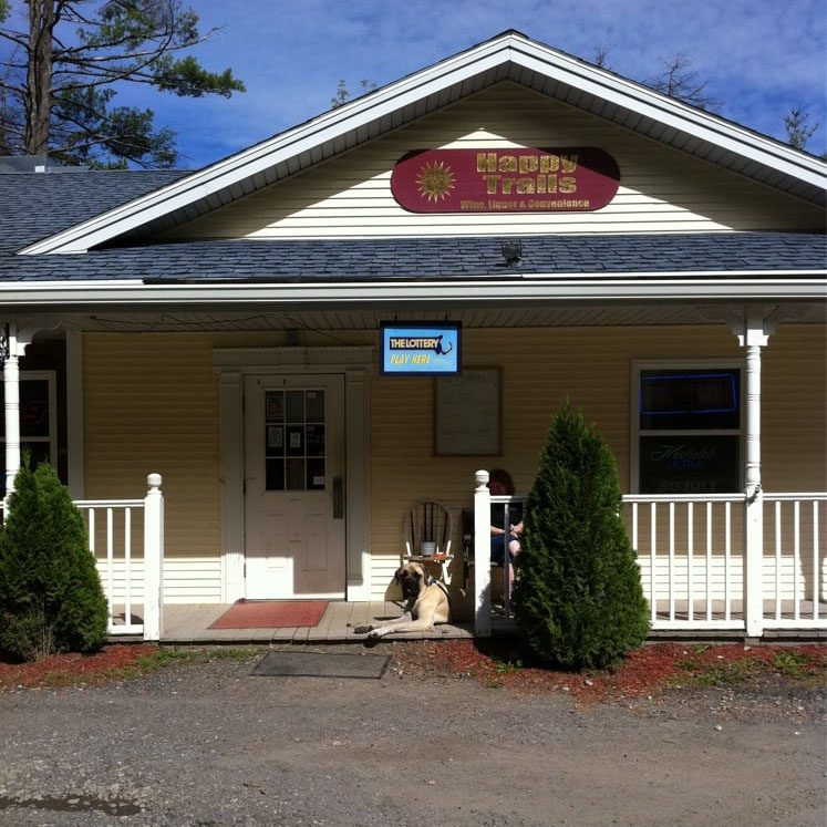 Building with front porch and dog on the porch
